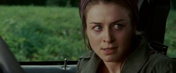 Movie still from “Edge of Darkness” (2010), directed by Martin Campbell – A person in a car with trees in the background; Close Up shot, Over the shoulder angle