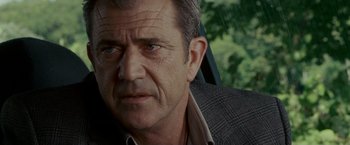 Movie still from “Edge of Darkness” (2010), directed by Martin Campbell – A person wearing a suit and tie; Close Up shot, Over the shoulder angle