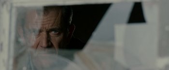 Movie still from “Edge of Darkness” (2010), directed by Martin Campbell – A person's face looking through a window; Close Up shot, Low angle