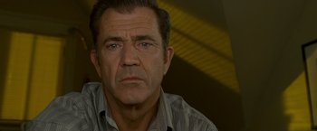 Movie still from “Edge of Darkness” (2010), directed by Martin Campbell – A person wearing a striped shirt; Close Up shot, Low angle