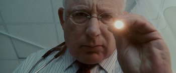 Movie still from “Edge of Darkness” (2010), directed by Martin Campbell – An older man wearing glasses looking at the camera; Close Up shot, Low angle