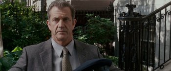 Movie still from “Edge of Darkness” (2010), directed by Martin Campbell – A person wearing a suit and tie; Close Up shot, Over the shoulder angle