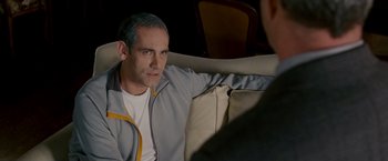 Movie still from “Edge of Darkness” (2010), directed by Martin Campbell – A man sitting on a couch looking at another man; Close Up shot, Over the shoulder angle