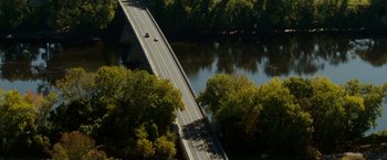 Movie still from “Edge of Darkness” (2010), directed by Martin Campbell – An aerial view of a bridge over a body of water; Extreme Wide shot, High angle