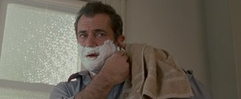 Movie still from “Edge of Darkness” (2010), directed by Martin Campbell – A man shaving his face while holding a razor; Close Up shot, Over the shoulder angle