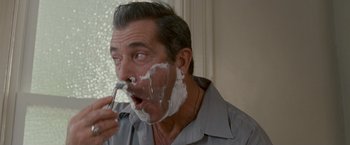 Movie still from “Edge of Darkness” (2010), directed by Martin Campbell – A person with shaving cream on his face; Close Up shot, Over the shoulder angle