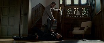 Movie still from “Edge of Darkness” (2010), directed by Martin Campbell – Two men in suits are on the floor; Wide shot, Low angle