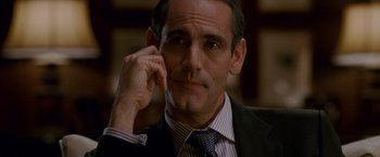 Movie still from “Edge of Darkness” (2010), directed by Martin Campbell – A man in a suit and tie; Close Up shot, Over the shoulder angle