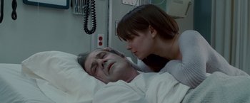 Movie still from “Edge of Darkness” (2010), directed by Martin Campbell – A man and a woman laying in a hospital bed; Close Up shot, Over the shoulder angle