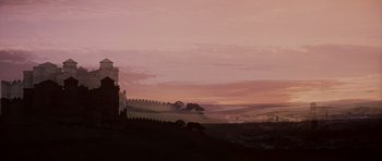 Movie still from “El Cid” (1961), directed by Anthony Mann – A painting of a castle on a hill at sunset; Extreme Wide shot, Low angle