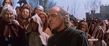 Movie still from “El Cid” (1961), directed by Anthony Mann – An old man in a crowd of people; Medium shot, Over the shoulder angle