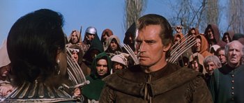 Movie still from “El Cid” (1961), directed by Anthony Mann – A group of men standing in front of each other; Medium shot, Over the shoulder angle