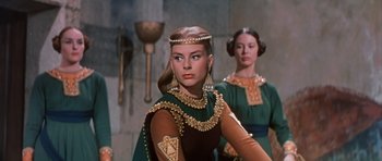 Movie still from “El Cid” (1961), directed by Anthony Mann – A woman in a dress and a woman in a green dress; Medium shot, Low angle