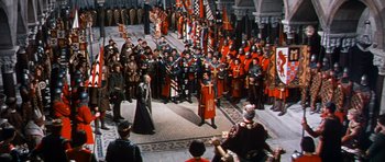 Movie still from “El Cid” (1961), directed by Anthony Mann – A crowd of people in orange and black uniforms; Extreme Wide shot, High angle