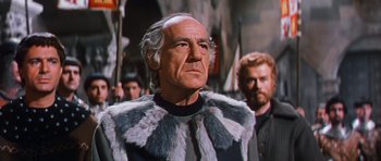 Movie still from “El Cid” (1961), directed by Anthony Mann – An older man wearing a fur coat in front of a crowd; Close Up shot, Low angle