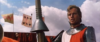 Movie still from “El Cid” (1961), directed by Anthony Mann – A man in a medieval costume holding a spear; Close Up shot, Low angle
