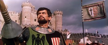 Movie still from “El Cid” (1961), directed by Anthony Mann – A man with a beard wearing a medieval costume; Medium shot, Low angle