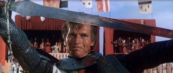 Movie still from “El Cid” (1961), directed by Anthony Mann – A person holding a sword; Close Up shot, Low angle