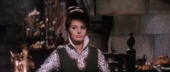 Movie still from “El Cid” (1961), directed by Anthony Mann – A woman in a black and white outfit sitting in a chair; Close Up shot, Low angle