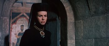 Movie still from “El Cid” (1961), directed by Anthony Mann – A woman in a black dress with a necklace; Close Up shot, Low angle