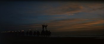 Movie still from “El Cid” (1961), directed by Anthony Mann – A group of people standing next to each other on the beach; Extreme Wide shot, Low angle