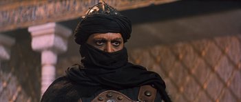 Movie still from “El Cid” (1961), directed by Anthony Mann – A man wearing a black turban and a leather jacket; Close Up shot, Low angle