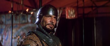 Movie still from “El Cid” (1961), directed by Anthony Mann – A person wearing a helmet; Close Up shot, Low angle