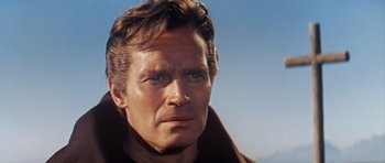 Movie still from “El Cid” (1961), directed by Anthony Mann – A man's face with a blue sky background; Close Up shot, Low angle