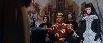 Movie still from “El Cid” (1961), directed by Anthony Mann – A group of men standing next to each other in front of a painting; Medium shot, Low angle