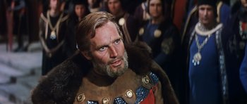 Movie still from “El Cid” (1961), directed by Anthony Mann – A man with a long beard wearing a fur coat; Close Up shot, Over the shoulder angle