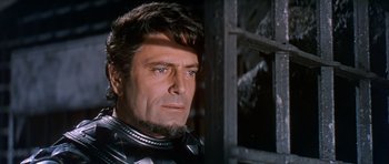 Movie still from “El Cid” (1961), directed by Anthony Mann – A person wearing a suit of armor; Close Up shot, Low angle