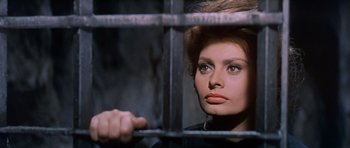 Movie still from “El Cid” (1961), directed by Anthony Mann – A person behind a metal fence; Close Up shot, Low angle