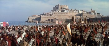 Movie still from “El Cid” (1961), directed by Anthony Mann – A crowd of people in medieval costumes on a beach; Extreme Wide shot, High angle