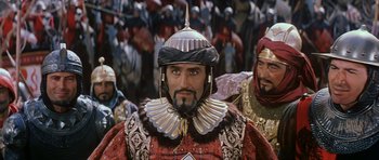Movie still from “El Cid” (1961), directed by Anthony Mann – A group of men in costume in front of a crowd; Medium shot, Over the shoulder angle