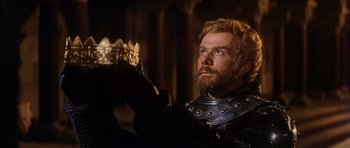 Movie still from “El Cid” (1961), directed by Anthony Mann – A man wearing a crown while holding something in his hand; Close Up shot, Low angle
