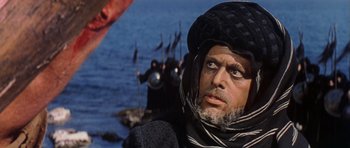 Movie still from “El Cid” (1961), directed by Anthony Mann – An older man in a turban looking at the camera; Close Up shot, Low angle