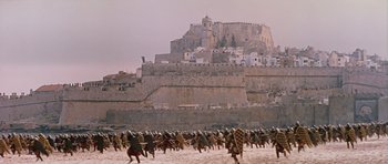 Movie still from “El Cid” (1961), directed by Anthony Mann – A large group of people riding horses in the sand; Extreme Wide shot, High angle