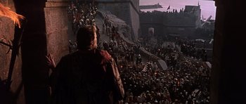 Movie still from “El Cid” (1961), directed by Anthony Mann – A large crowd of people are gathered in the middle of a city; Extreme Wide shot, High angle