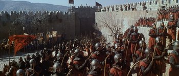 Movie still from “El Cid” (1961), directed by Anthony Mann – A crowd of men in medieval garb are gathered in front of a wall; Extreme Wide shot, High angle