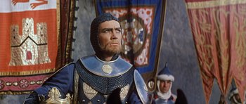 Movie still from “El Cid” (1961), directed by Anthony Mann – A man in a suit of a medieval knight; Close Up shot, Low angle