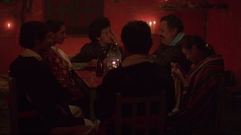 Movie still from “El Norte” (1983), directed by Gregory Nava – A group of people sitting around a table at a restaurant; Medium shot, High angle