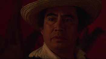 Movie still from “El Norte” (1983), directed by Gregory Nava – A person wearing a straw hat; Close Up shot, Over the shoulder angle