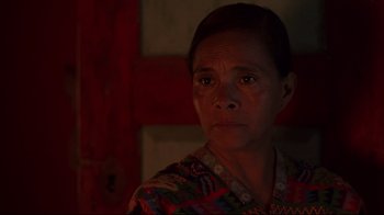 Movie still from “El Norte” (1983), directed by Gregory Nava – A person wearing a colorful shirt; Close Up shot, High angle