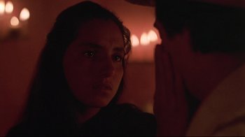 Movie still from “El Norte” (1983), directed by Gregory Nava – A young woman looking at the camera with her eyes wide open; Close Up shot, Over the shoulder angle