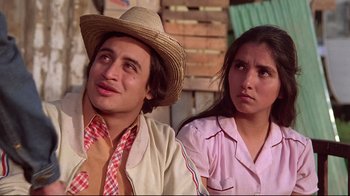 Movie still from “El Norte” (1983), directed by Gregory Nava – A man and a woman are sitting next to each other; Close Up shot, Low angle