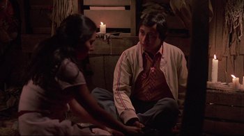 Movie still from “El Norte” (1983), directed by Gregory Nava – A man and a woman sitting on the floor; Medium shot, High angle
