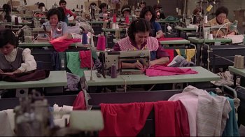 Movie still from “El Norte” (1983), directed by Gregory Nava – A group of people working in a sewing room; Wide shot, High angle