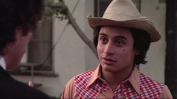 Movie still from “El Norte” (1983), directed by Gregory Nava – A young man wearing a cowboy hat and a plaid shirt; Close Up shot, Low angle