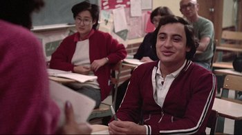 Movie still from “El Norte” (1983), directed by Gregory Nava – A group of people sitting in a classroom; Medium shot, Over the shoulder angle