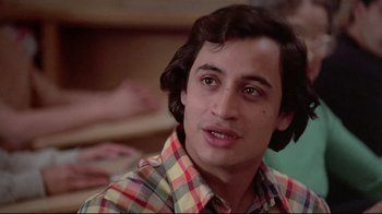 Movie still from “El Norte” (1983), directed by Gregory Nava – A young man in a plaid shirt is looking at the camera; Close Up shot, Low angle